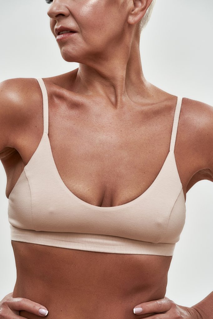 Woman in a bra – breast surgery at Alpha Hospital Group