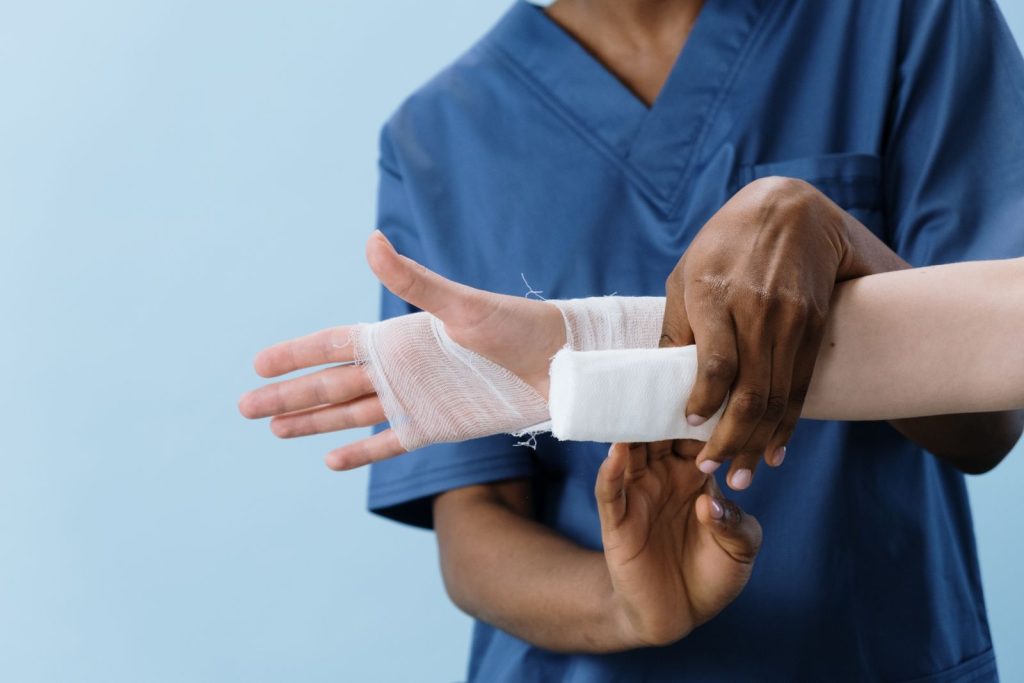 Nurse dressing a post-operative wound at Alpha Hospital Group